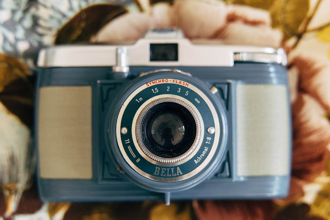 Silver and Gray Camera on Brown Surface