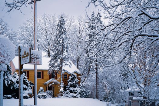 Cozy suburban street blanketed in fresh winter snow creates a picturesque scene.