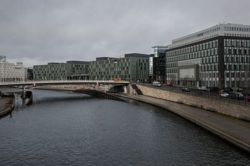 Free Contemporary buildings by the Spree River with a bridge, Berlin, Germany. Stock Photo