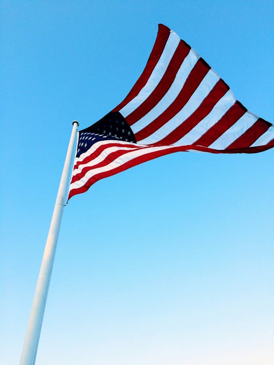 Free USA Flag on Pole Under Blue Sky Stock Photo