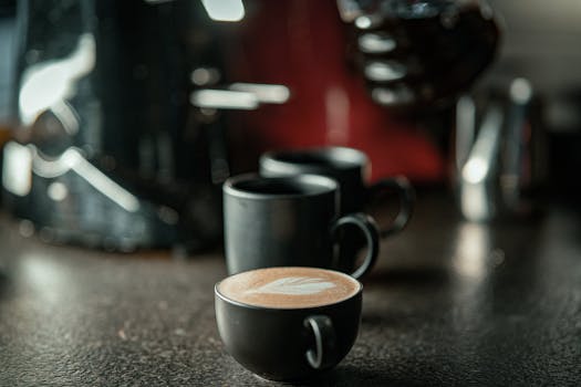 Close-up of artisan coffee cups with latte art in a cozy café setting.