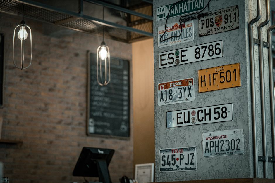 Charming cafe interior in Bursa, showcasing vintage license plates on textured walls.