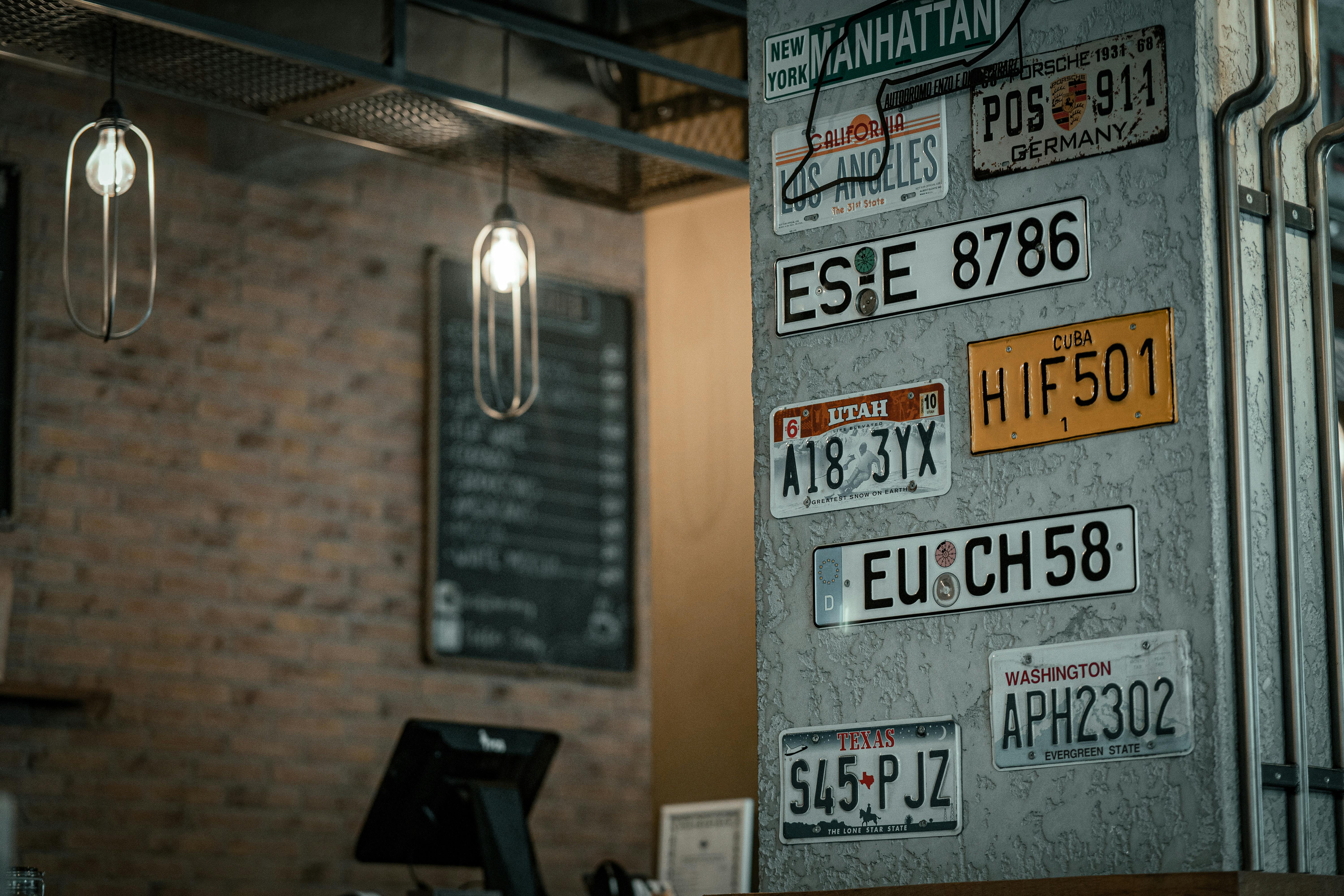 Free Charming cafe interior in Bursa, showcasing vintage license plates on textured walls. Stock Photo
