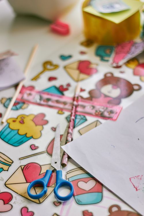 Free A vibrant assortment of craft supplies featuring scissors, ruler, and patterned paper. Stock Photo