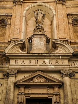 Detailed view of Baroque architecture in Valletta, showcasing ornate columns and statues.
