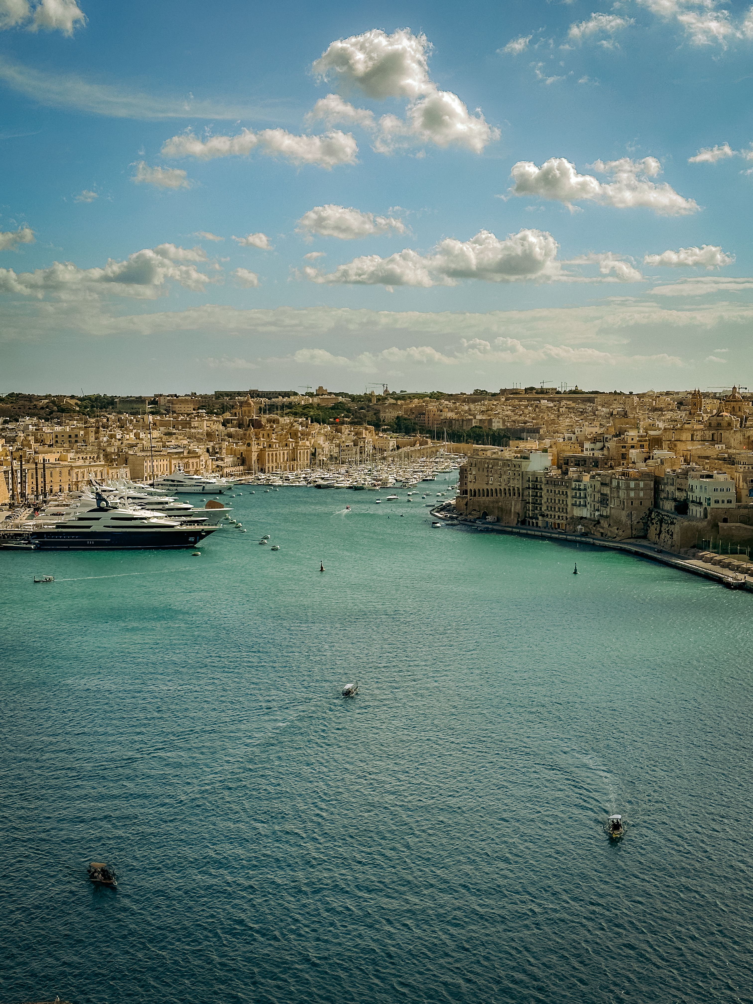 Grand Harbour view in Valletta, Malta with yachts and historic limestone buildings