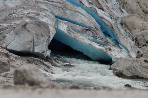 Free Stunning close-up of a glacier with a flowing stream, showcasing nature's raw beauty. Stock Photo