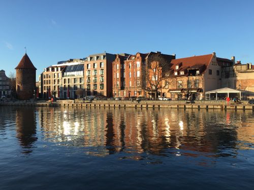 Free Sunny day reflection of waterfront buildings in Gdańsk, Poland. Stock Photo