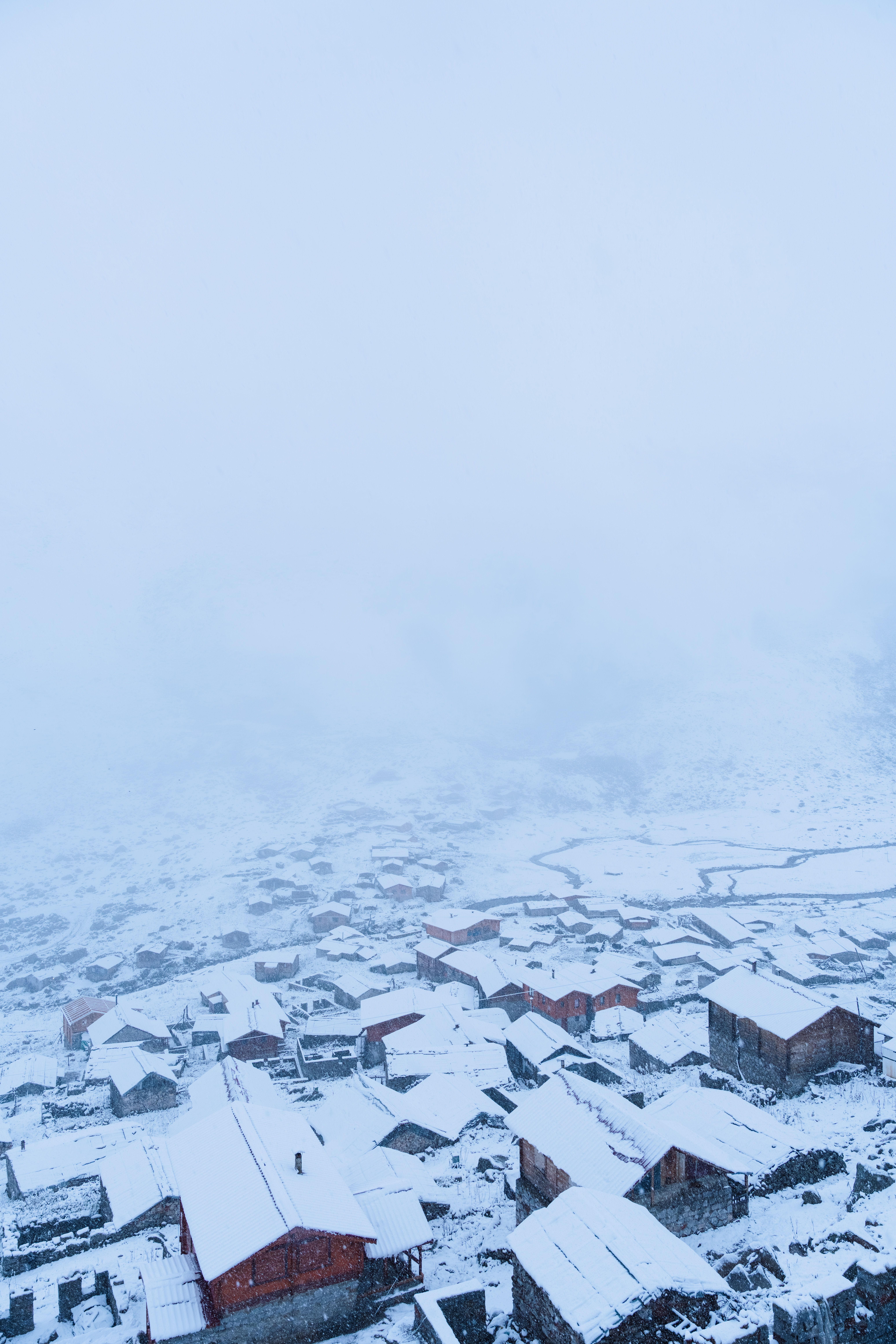 Aerial View of Snow-Covered Village in Winter · Free Stock Photo