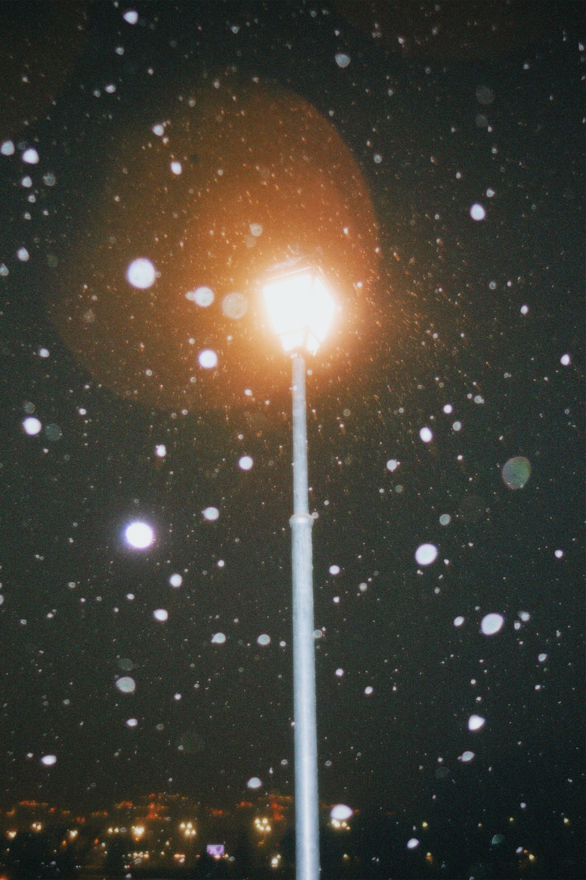 Night Snowfall Around Glowing Street Lamp · Free Stock Photo