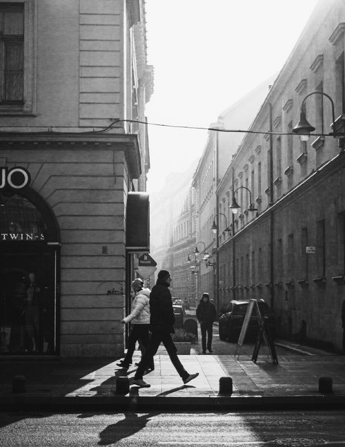 Free An urban street scene in Sarajevo in black and white, capturing pedestrians and light play. Stock Photo