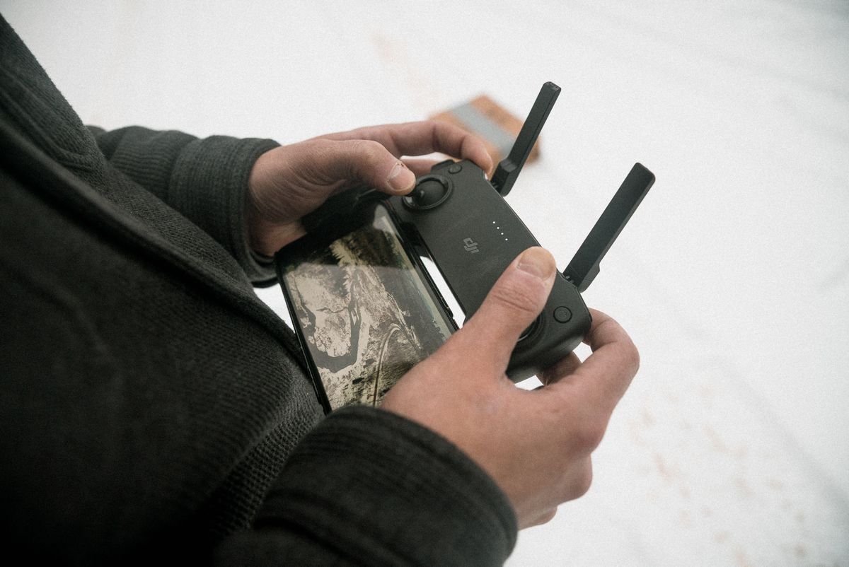 Student hands on a drone controller during a training flight