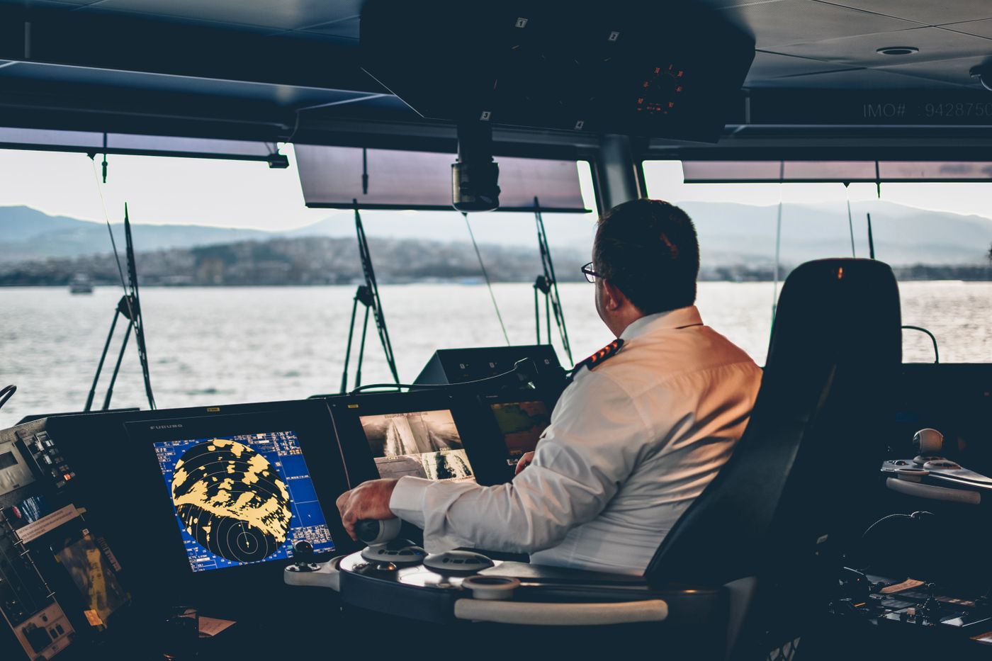 Ship captain operating navigation systems overlooking Istanbul waters