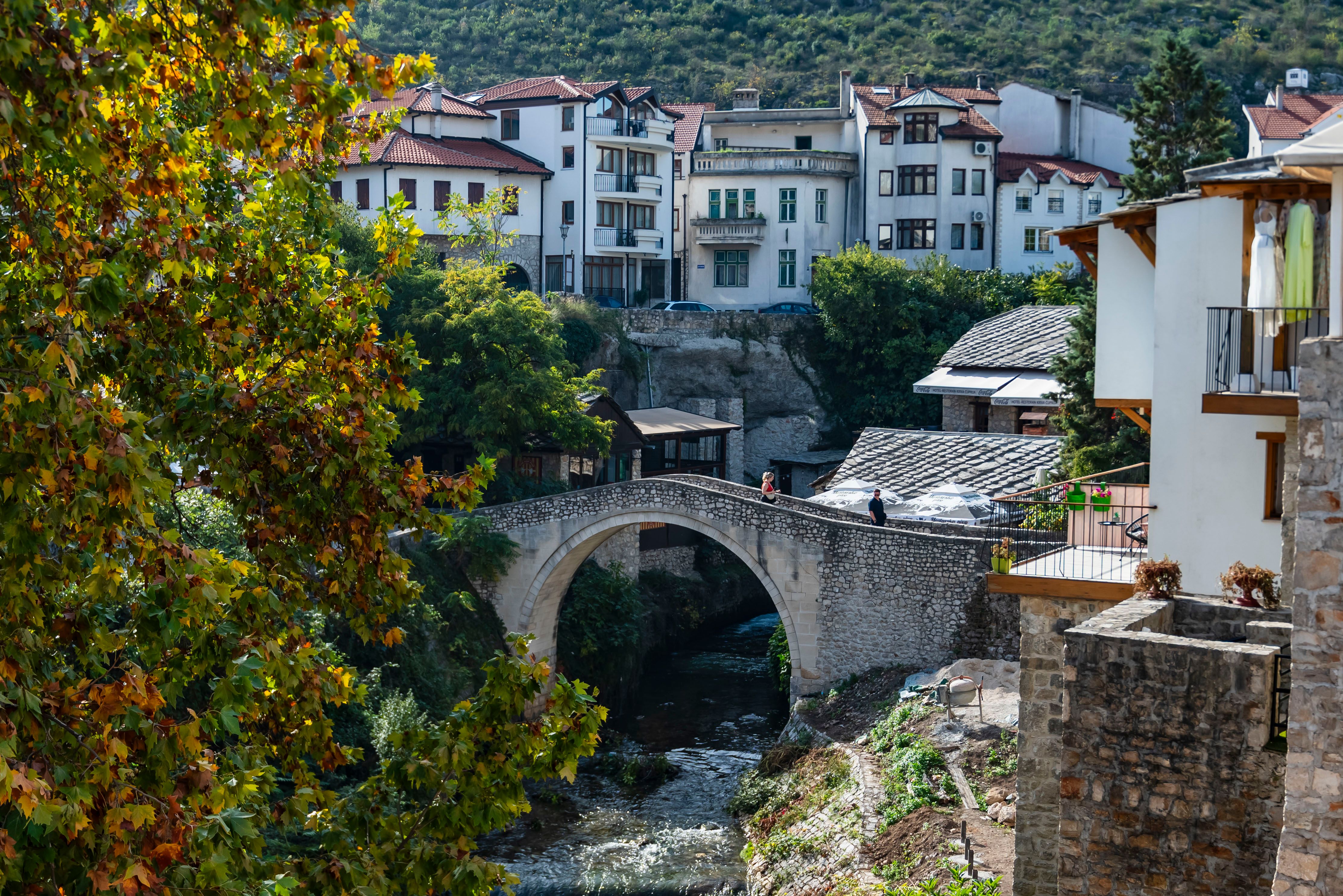 Historic Bridge in Mostar with Autumn Foliage · Free Stock Photo