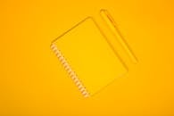 Vibrant Yellow Notebook and Pen Flat Lay