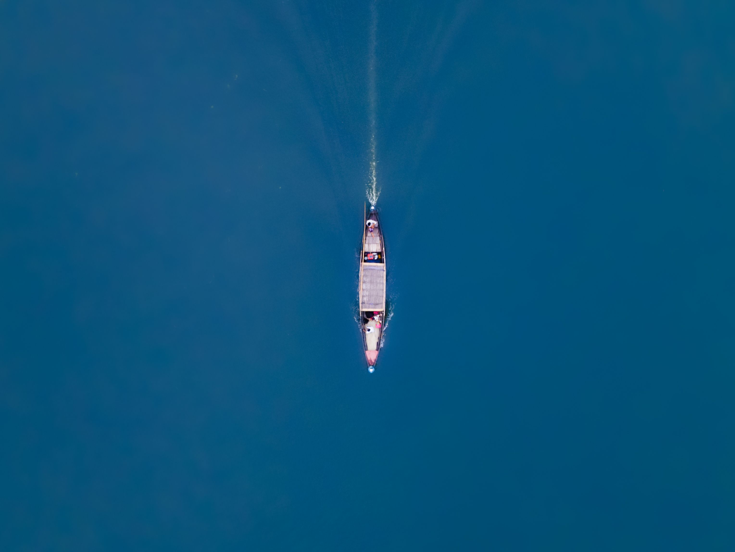 Aerial View of a Boat on Blue Water · Free Stock Photo