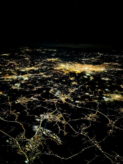 Stunning aerial view of a Spanish city illuminated at night, showcasing urban lights.