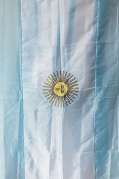 A detailed look at the Argentine flag featuring the iconic Sun of May emblem.