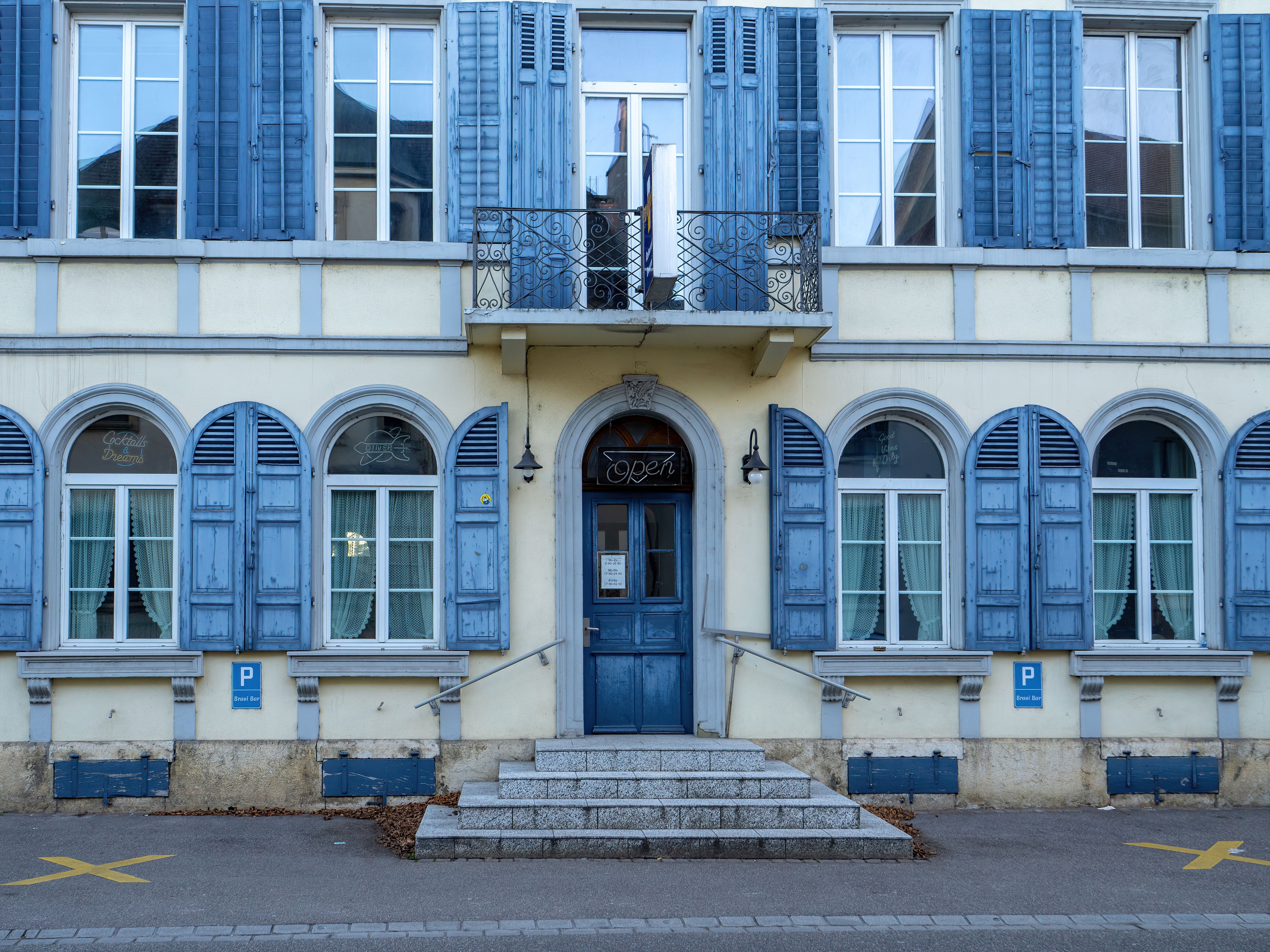 Charming Blue Shuttered Building Facade · Free Stock Photo