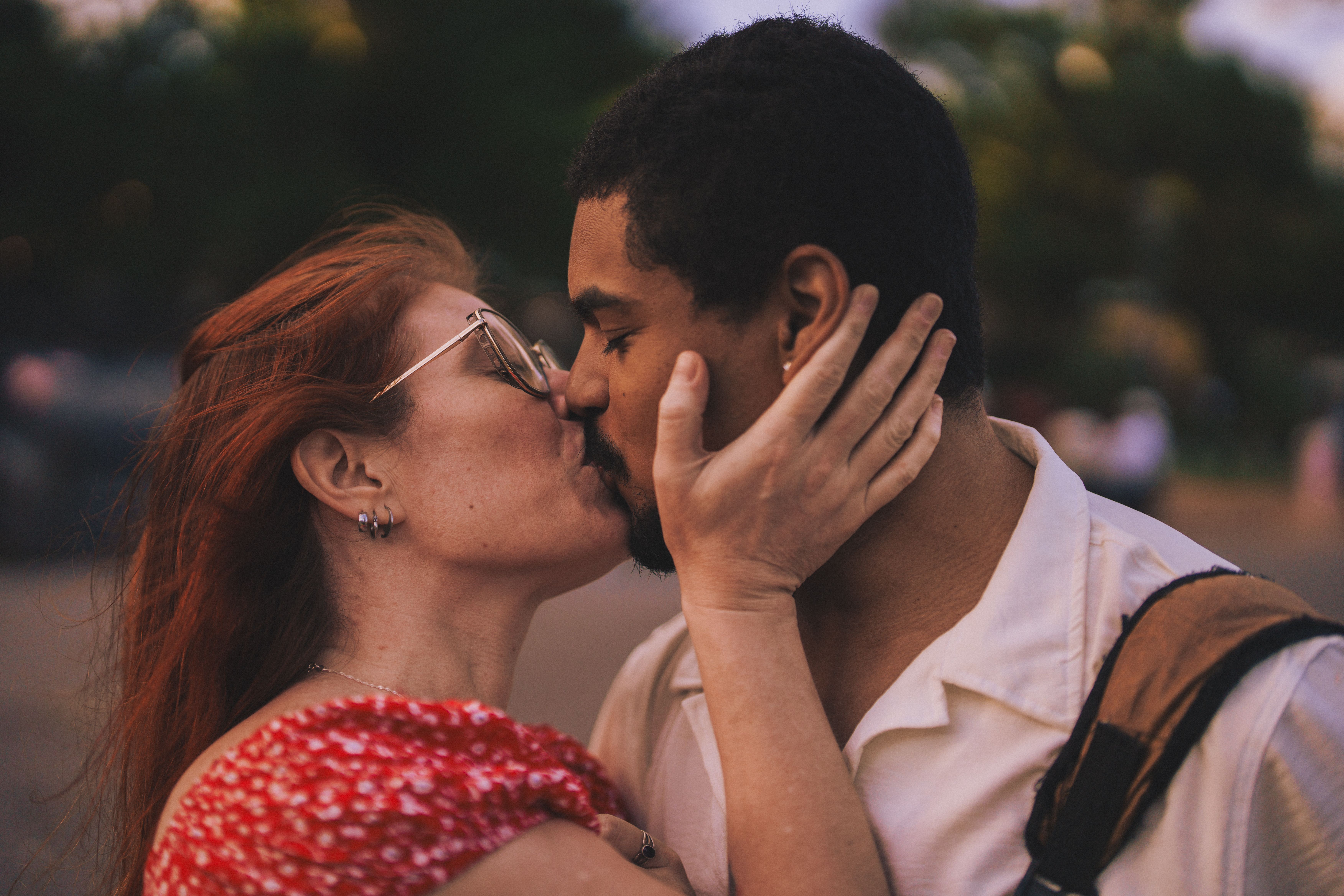 Romantic Couple Sharing a Tender Kiss Outdoors · Free Stock Photo