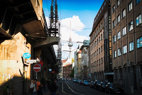 Free Street view in Berlin featuring the famous Fernsehturm tower with urban architecture and lively atmosphere. Stock Photo