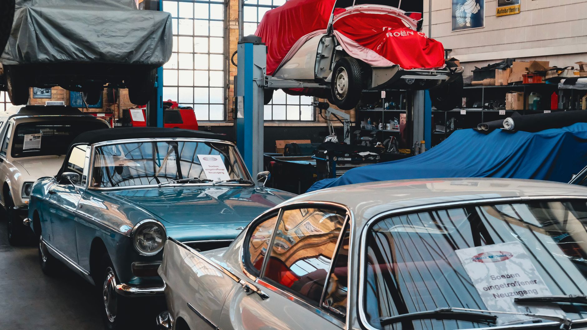 Classic cars showcased in an automotive garage with vibrant details.