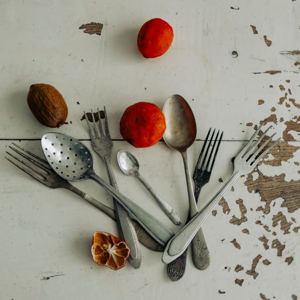 Vintage cutlery and fruit on a distressed table — Alexander Zvir on Pexels