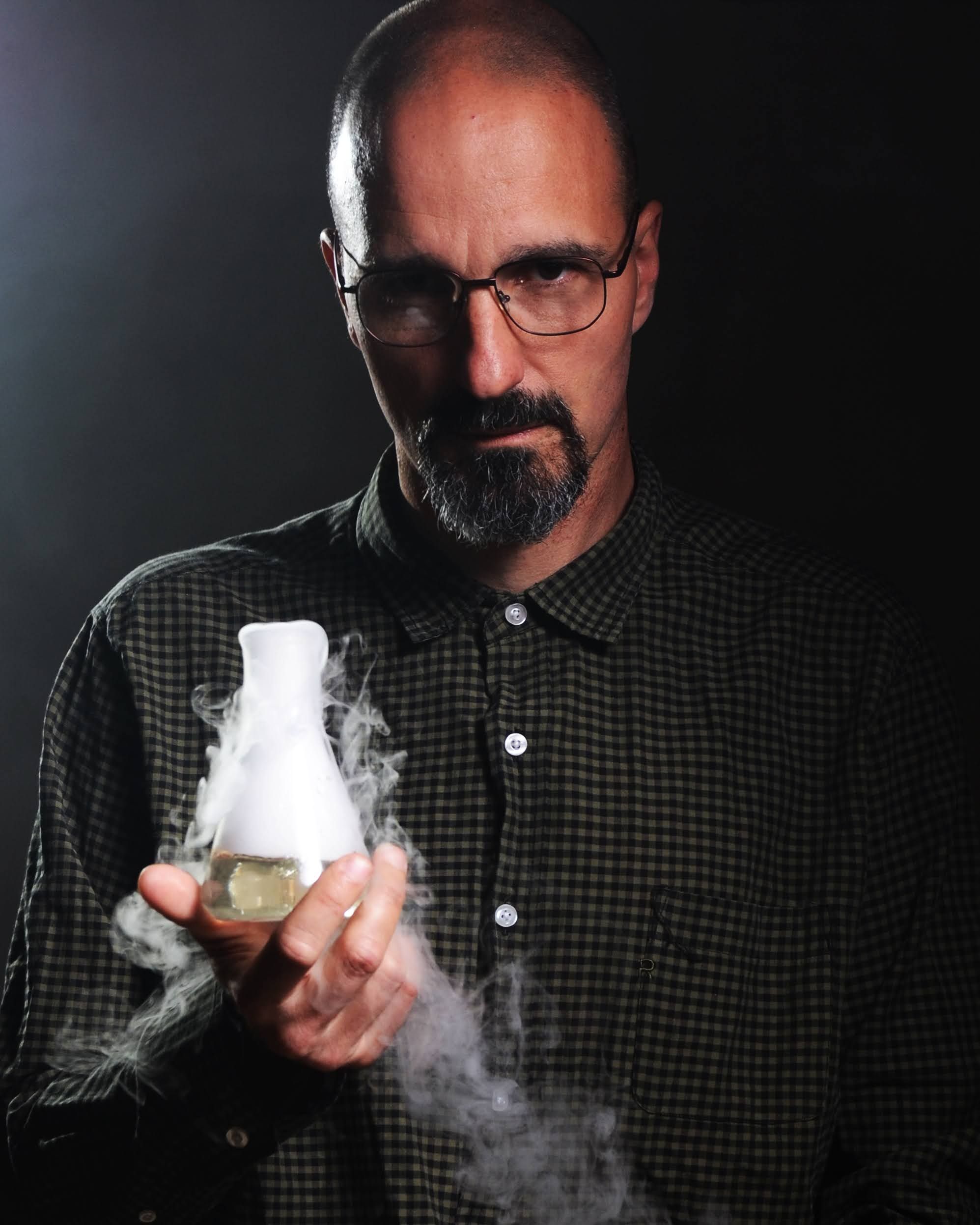 Male Scientist Holding Smoky Flask in Laboratory · Free Stock Photo