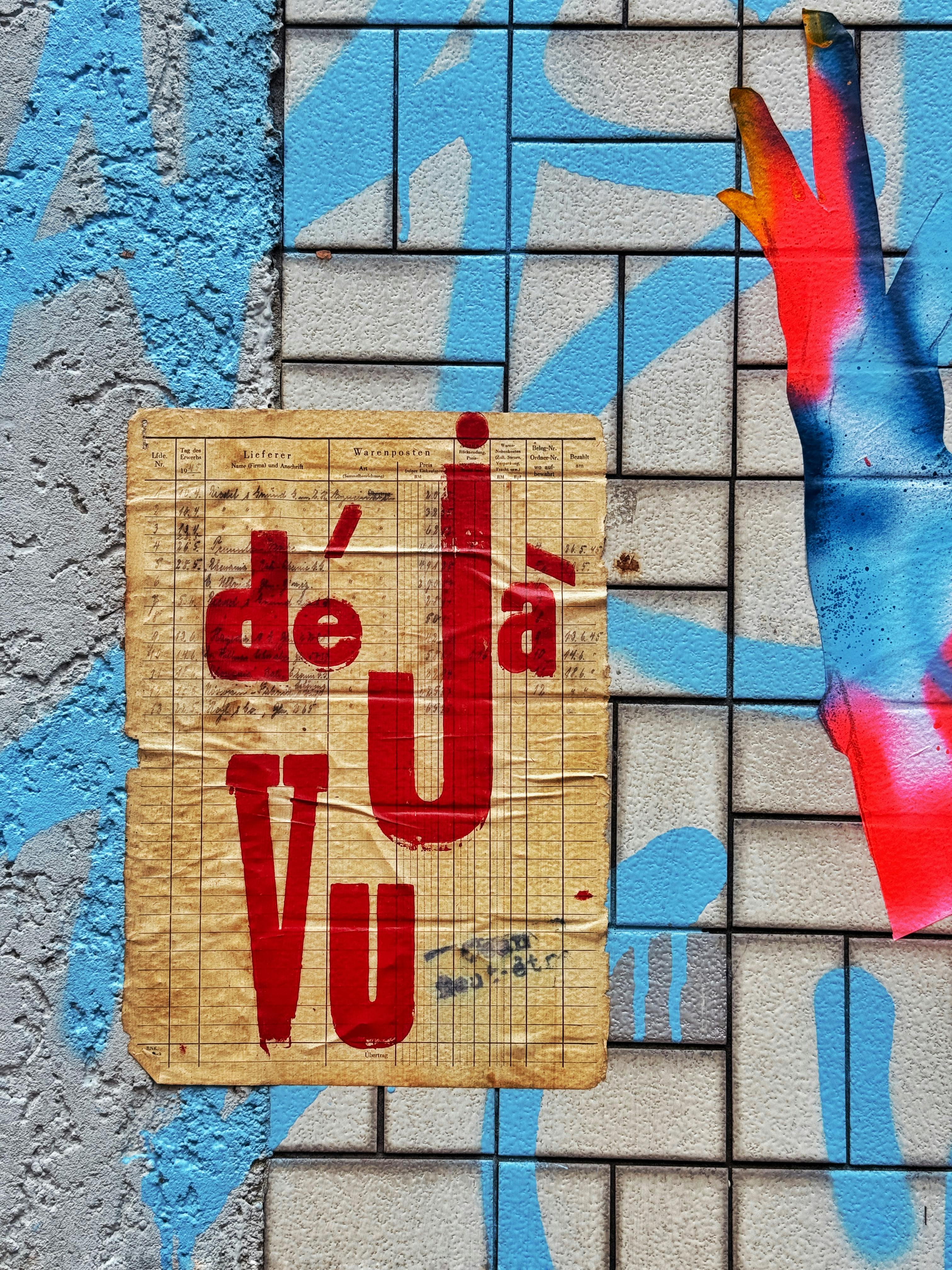 Vibrant graffiti in Berlin with bold colors and text 'déjà vu' on a textured wall.