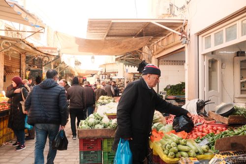 Free Lively scene at a local market in Sfax, showcasing vibrant produce and bustling crowds. Stock Photo