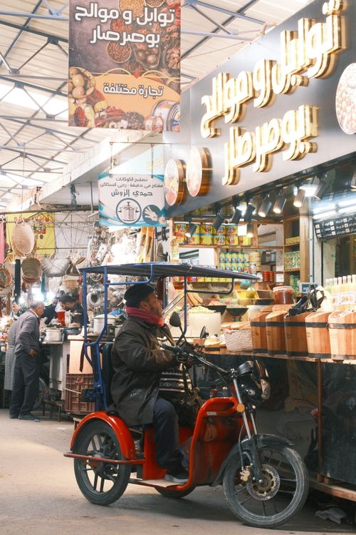 Free Colorful local market in Sfax, Tunisia with a man on a scooter, showcasing vibrant cultural diversity. Stock Photo
