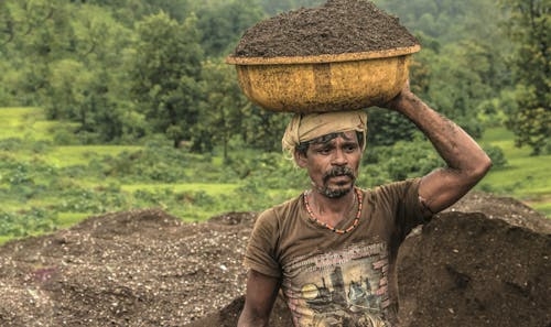 Man Carrying Basin of Soil on Top of His Head