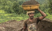 Man Carrying Basin of Soil on Top of His Head