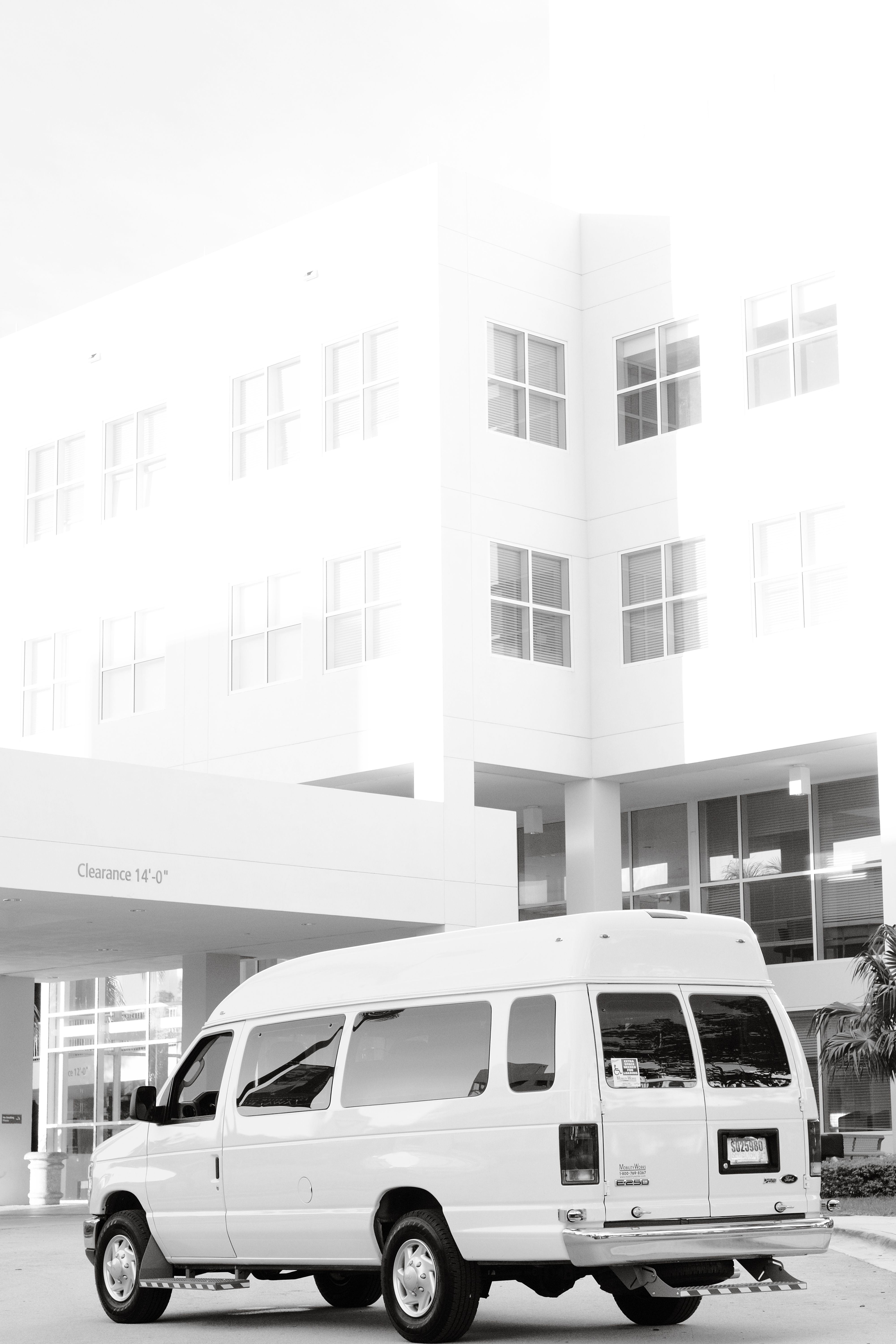 White Van Parked Outside Modern Building · Free Stock Photo