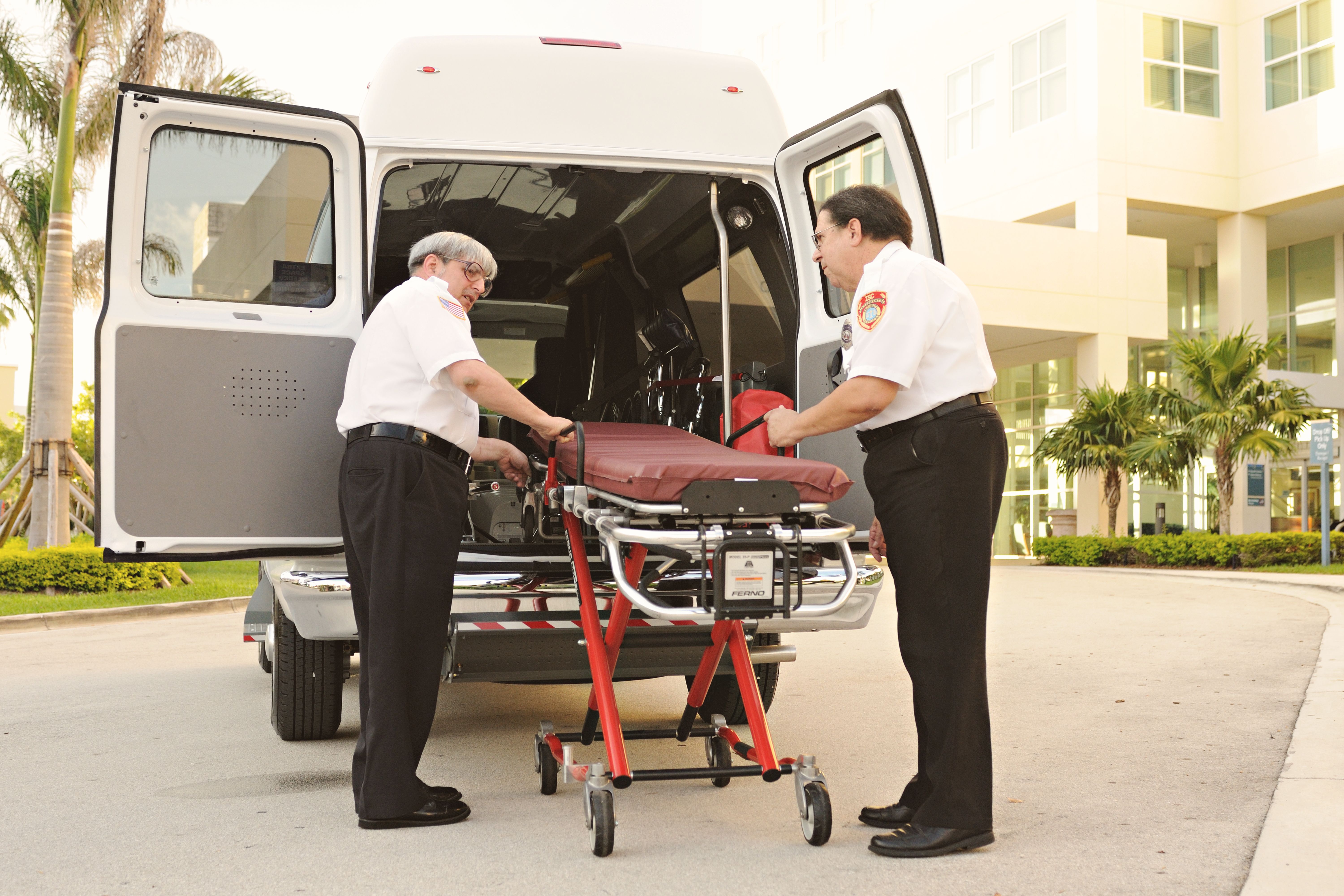 Paramedics Loading Stretcher into Ambulance Outside Hospital · Free ...