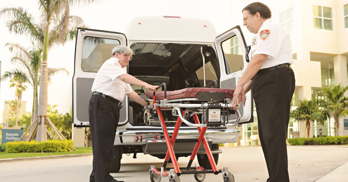 Photo by DΛVΞ GΛRCIΛ Two emergency responders load a stretcher into an ambulance outdoors, depicting medical assistance.
