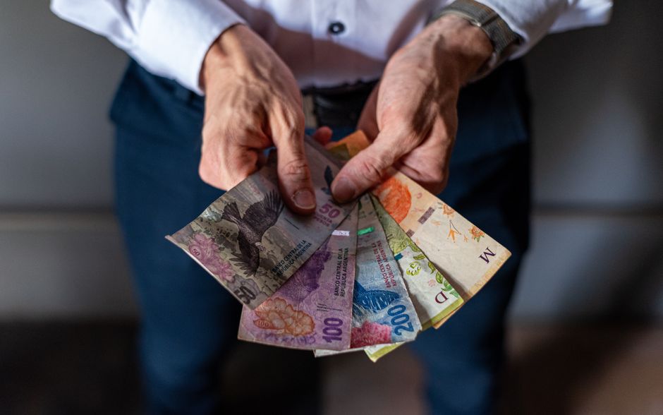 Maldivian Rufiyaa banknotes being exchanged at a local market stall on an inhabited island in the Maldives.