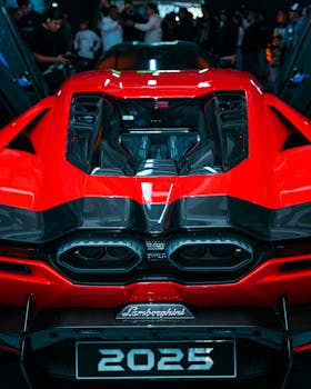 Dynamic view of a red sports car's rear at Puebla auto show, showcasing sleek design and performance.