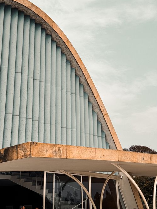 Free Close-up of a modern building's facade featuring geometric lines and soft sunlight. Stock Photo