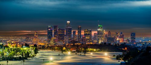 Free A breathtaking view of the illuminated Los Angeles skyline during twilight with vibrant city lights. Stock Photo