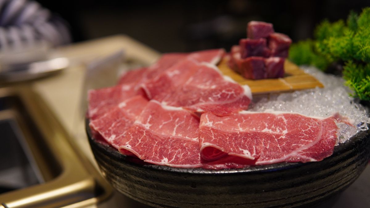 Thinly sliced beef on ice showing marbling — the key ingredient for both sukiyaki and shabu shabu