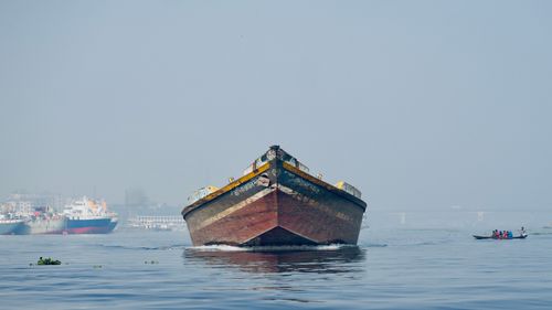 Free A large cargo ship on the Buriganga River, Dhaka, Bangladesh, under a clear sky. Stock Photo