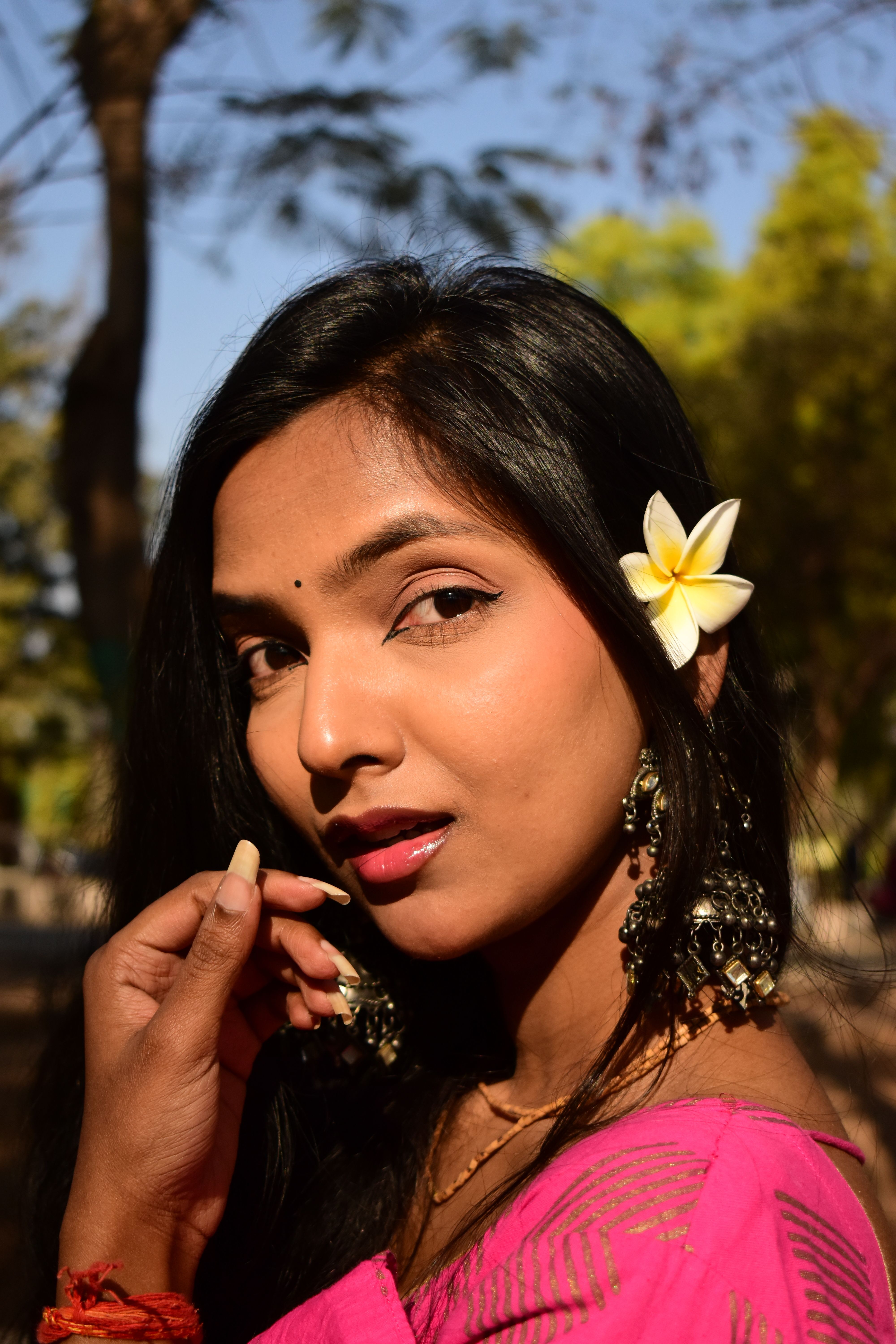 Portrait of a Woman with Flower in Hair · Free Stock Photo
