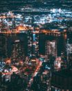 俯瞰繁华的城市夜景，明亮的灯光和现代建筑展现出无限活力