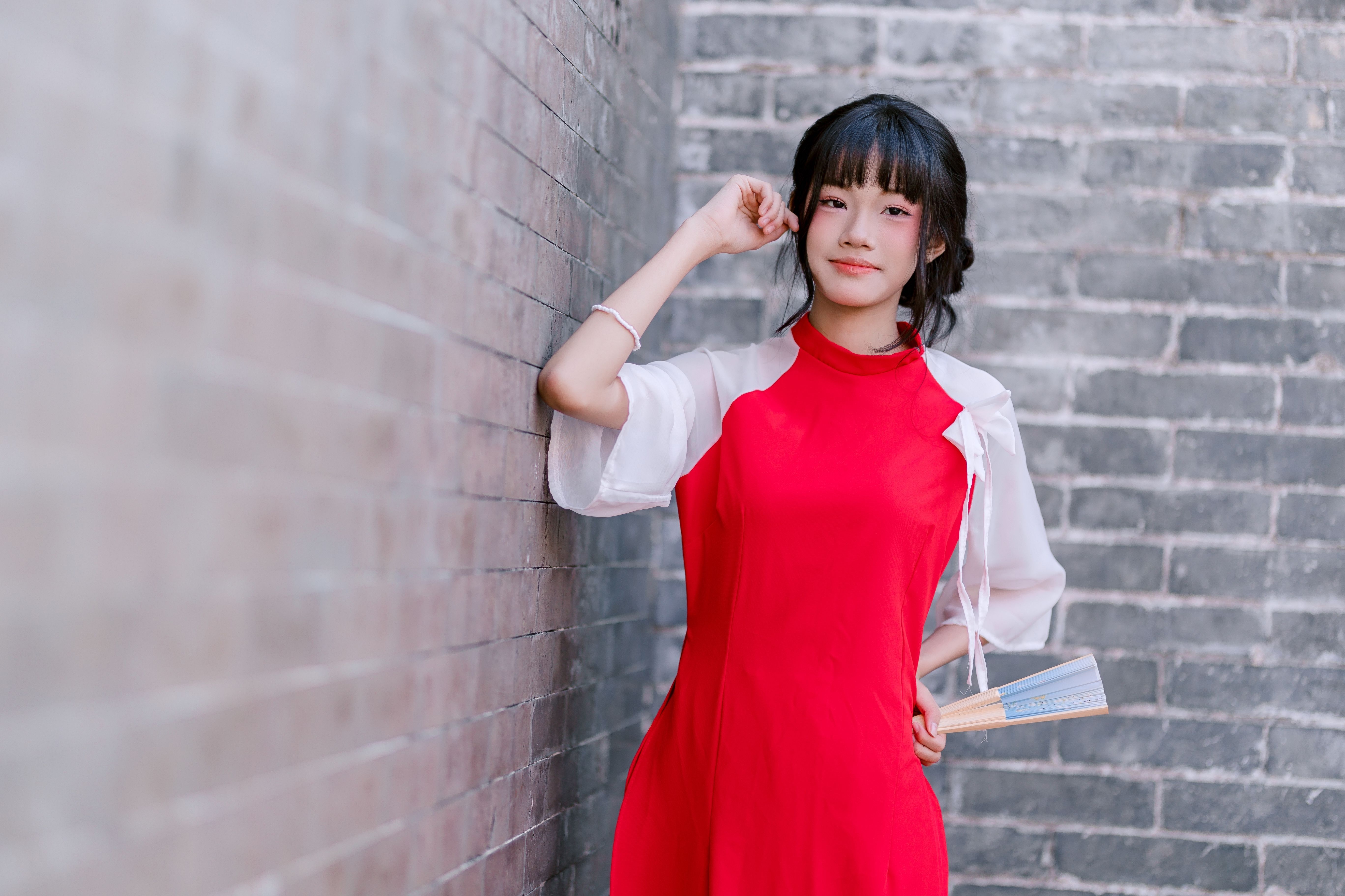 Portrait of Woman in Red Dress by Brick Wall · Free Stock Photo