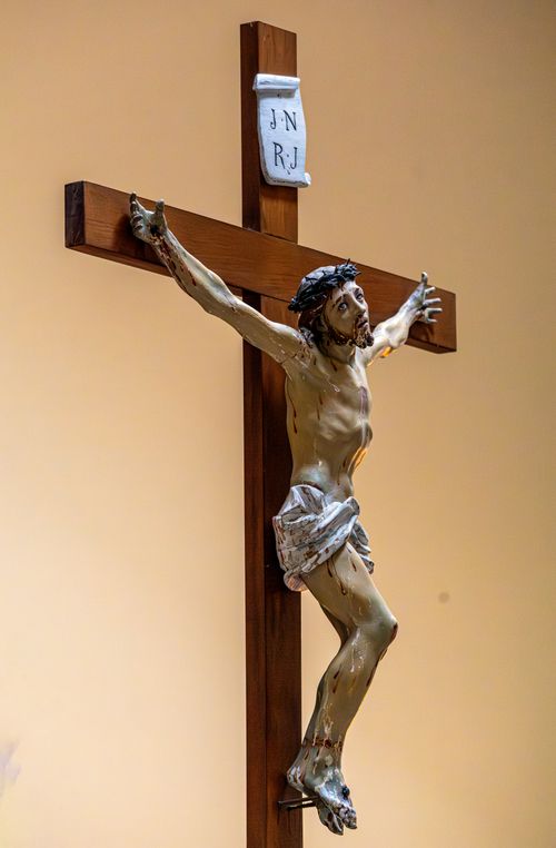 Free Detailed sculpture of Jesus Christ on a wooden cross, symbolizing Christianity. Stock Photo