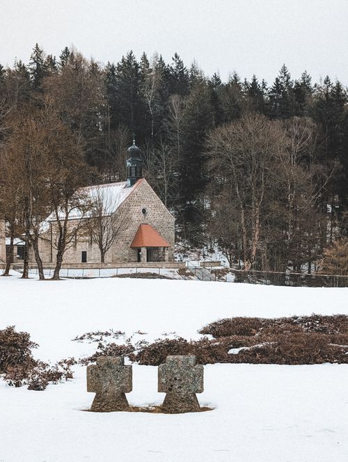 Free A serene winter landscape featuring a historic church surrounded by snow in Flossenbürg, Germany. Stock Photo