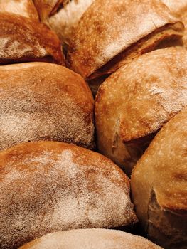 Close-up of freshly baked artisan bread loaves with a golden crust.