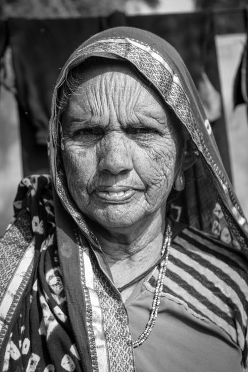 Free Grayscale portrait of an elderly woman wearing traditional attire, showcasing life's experience. Stock Photo