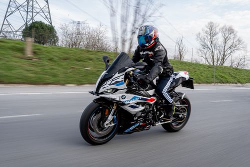 Free Dynamic shot of a motorcyclist wearing gear, speeding on a highway. Stock Photo